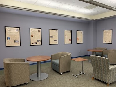 wall of framed posters in Belk Library highlighting work of diverse scholars