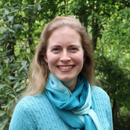 Photo of Greta Browning, long blond hair, teal sweater and scarf