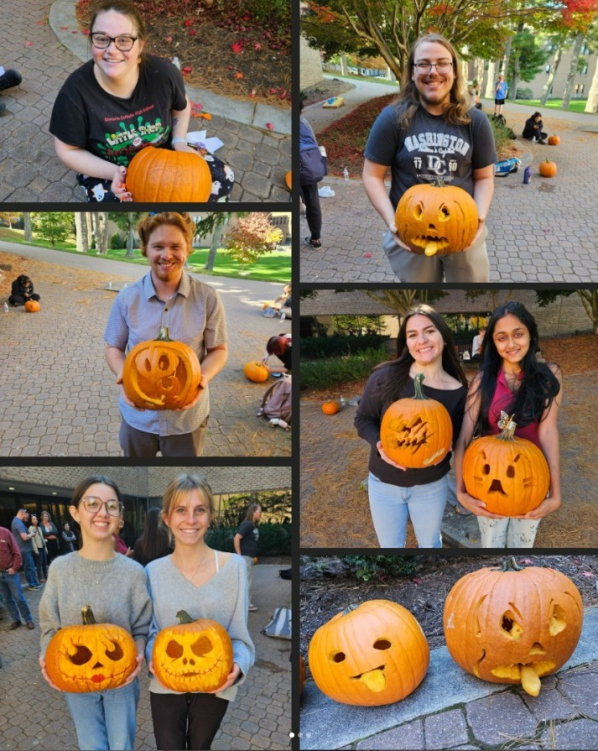 Winners of pumpkin carving contest holding decorated pumpkins