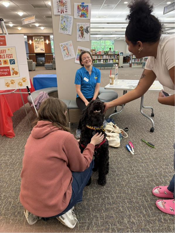 Photo of Therapy Dog greeting students at Finals Fest