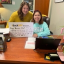 Library staff member Andrea Tester with library student employee Ivy Herrera holding an iBackAPP sign