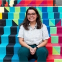 Krystal Carter seated on the brightly colored painted steps of the Turchin Center