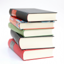 Photograph of multi colored book stack  