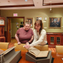 Hannah Helmey sharing book with Jecca Hodges for Open House