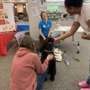 Photo of Therapy Dog greeting students at Finals Fest