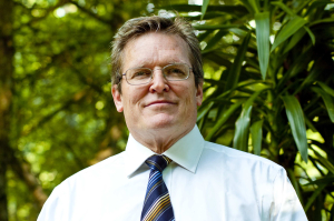 Photograph of Allan Scherlen in a white shirt and tie