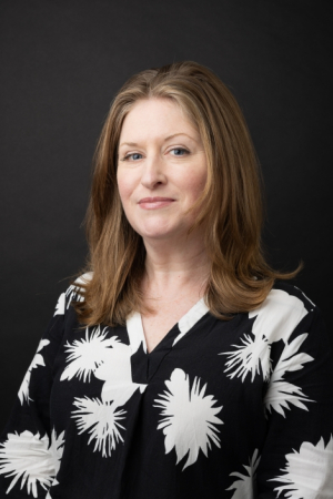 Emily Kader in a black blouse with white designs