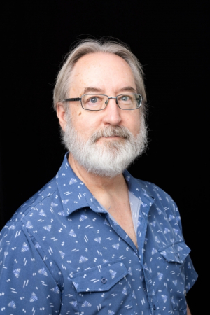 Dr. Gary Boye, blue shirt, white beard, glasses