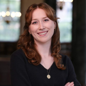 Hannah Helmey, shoulder length red hair, black sweater