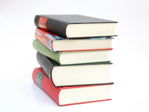 Photograph of multi colored book stack  