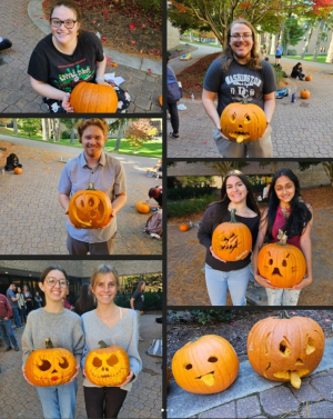 Winners of pumpkin carving contest holding decorated pumpkins