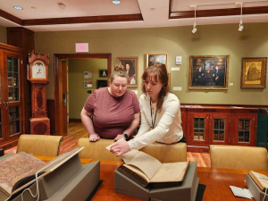 Hannah Helmey sharing book with Jecca Hodges for Open House