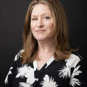 Emily Kader in a black blouse with white designs
