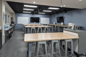 Student workspace and instruction area with screens and whiteboard