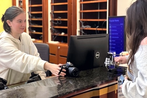 Student checking out a camera at the Tech Checkout Desk