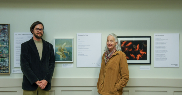 Candace Tippett standing by her award-winning poem and paired visual art on display