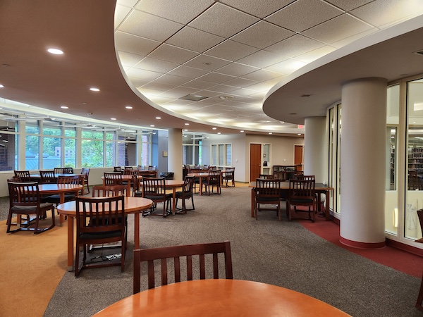 Large, open seating area on the second floor with two- and four-person tables and bright lighting