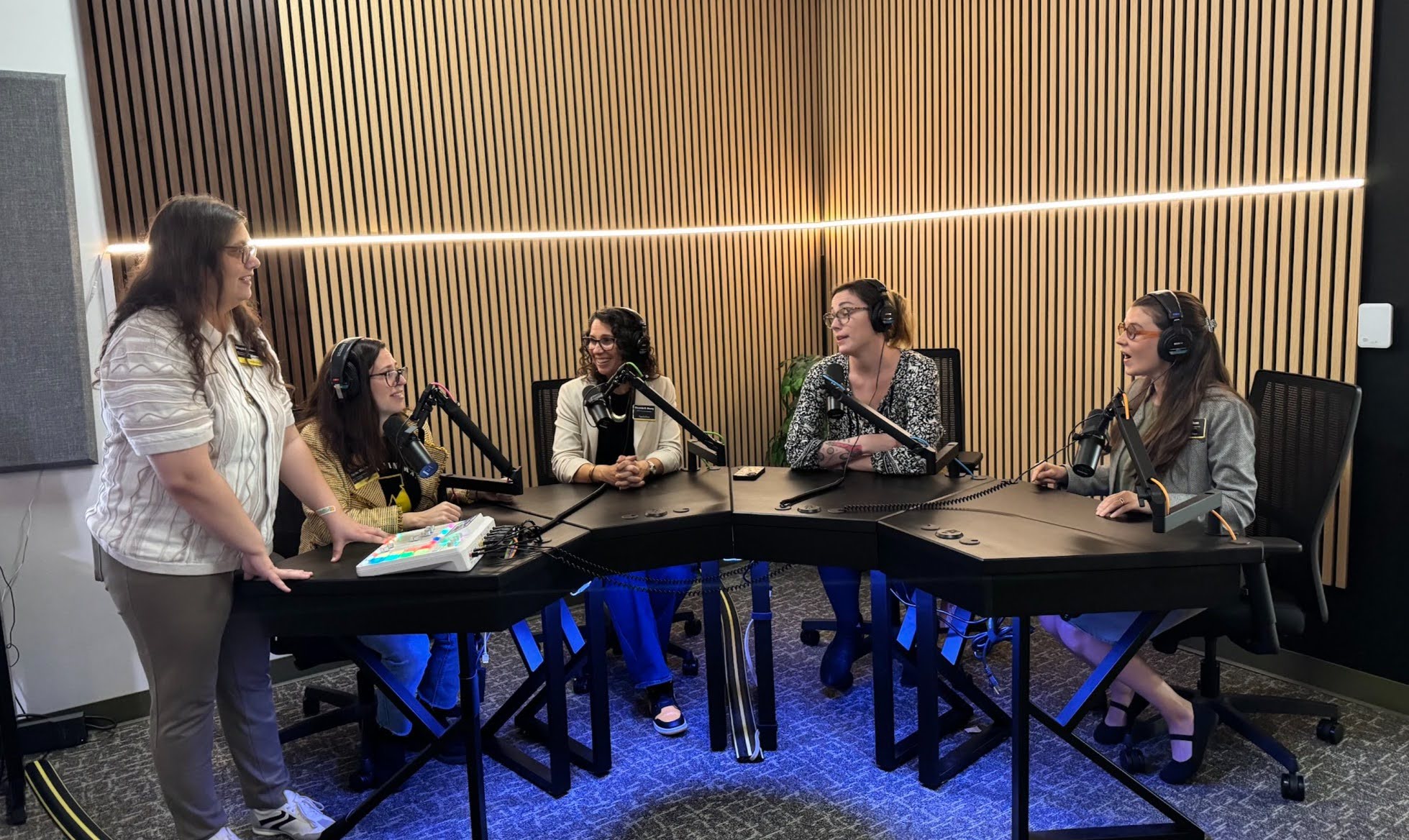 Employees from Access and Opportunity testing our podcasting station.